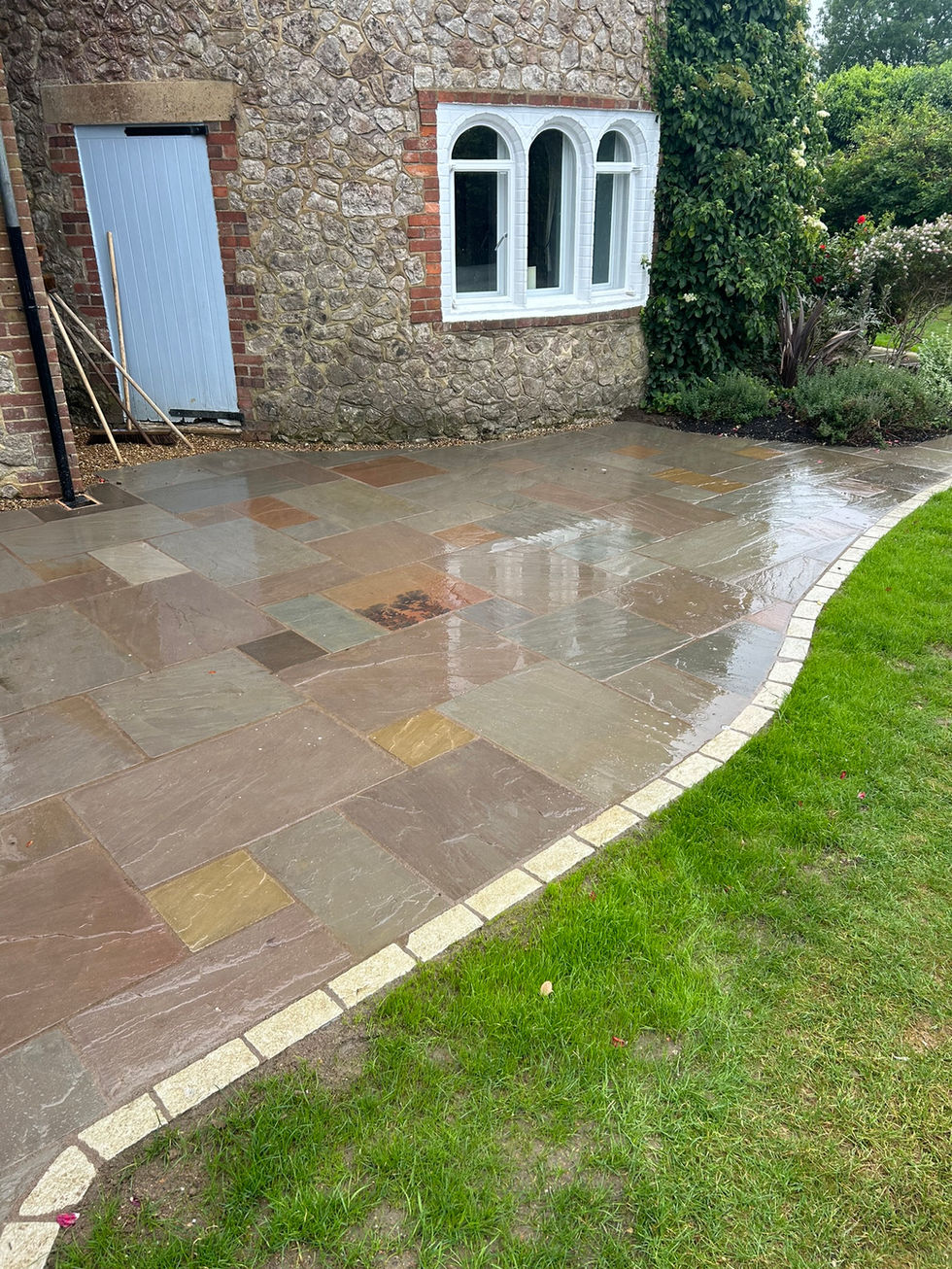 a stone walkway in front of a stone building