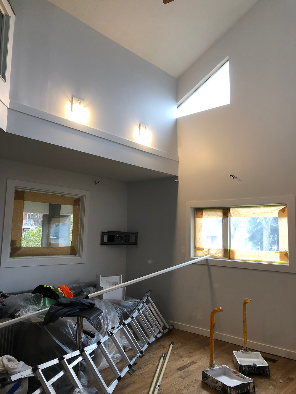 Preparation work for Mill Creek Painters painting contractors in a room with tall ceilings in Edmonton