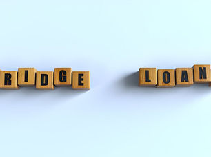 Wooden blocks spell "BRIDGE LOANS" on a light blue background, arranged neatly with a shadow effect.