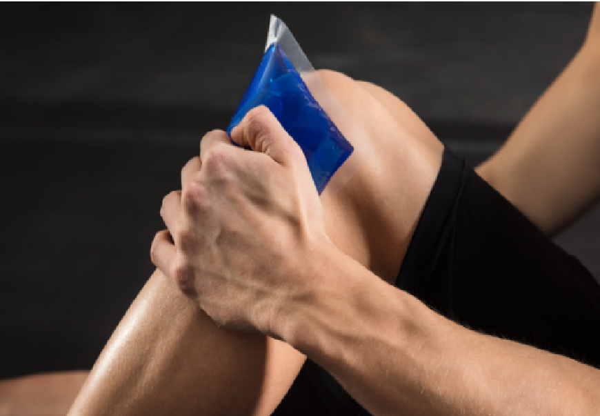 Professional athlete applying a flexible medical cold pack to an injured knee using a compression wrap.