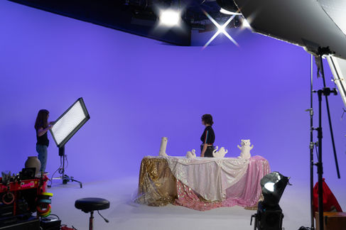 Studio setup with purple backdrop and lighting equipment.