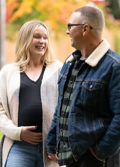 Smiling couple, woman holding her pregnant belly.