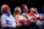 Grandfather with his grandchildren in the cinema watching the movie..jpg