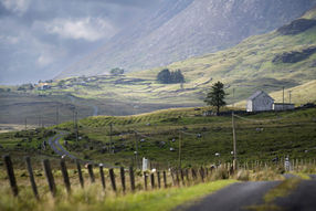An old school house in a large valley in Connemara, Ireland. Surrounded by mountains.