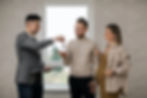 A real estate agent handing keys to a client aftering closing a sale