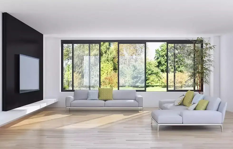 Modern living room with a large window, sofa, and television on wall.