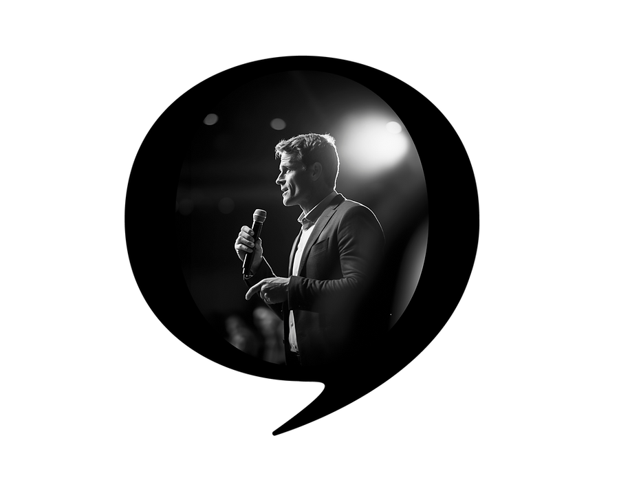 Professional male speaker delivering a public speaking presentation on stage while holding a microphone