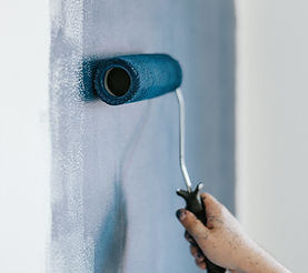 closeup-shot-female-using-paint-rollers-