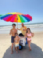 Top 10 Things to Do in Oak Island, NC include enjoying a King of Pops all-natural treat on the beach from their famous carts under the rainbow umbrella