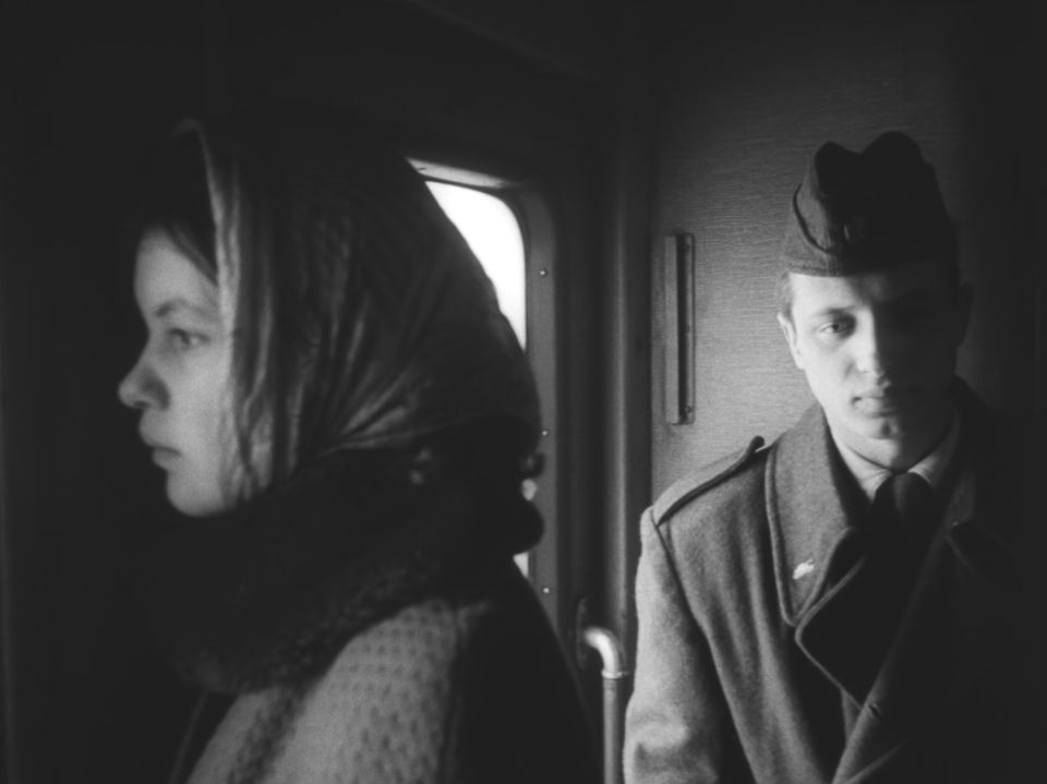 a man ad a woman next to a window on a train