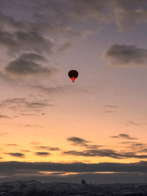 Hot air balloon flying during sunrise in Cappadocia Turkey