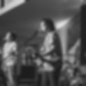 Black and white photo of man playing the guitar while leading worship during Young Adults Weekend at Thousand Pines Christian Camp.