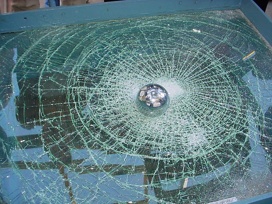 A shattered window protected by safety film.