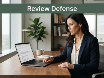 Business owner reviewing online feedback and managing fake reviews on a laptop