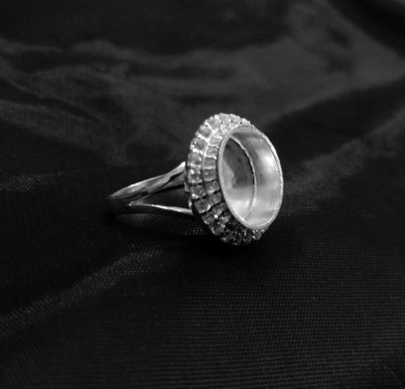 Thumbnail: 925 Sterling Silver Oval Shape Handcrafted Bezel Ring With Small CZ Gemstone.