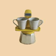 Stacked espresso maker set in yellow with ceramic mugs