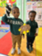 two young boys playingwith sock puppets at Kurios Kids learning center at West Baltimore United Methodist Church
