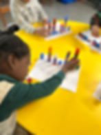 young girl using blocks creatively to learn math at Kurios Kids learning center at West Baltimore United Methodist Church
