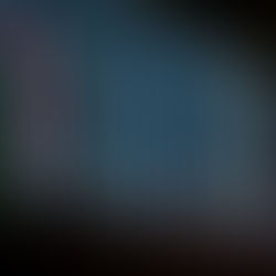 A long exposure of multicolored lights moving down a black background.