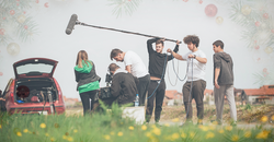 Film Crew standing outside with gear