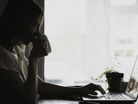 Taking a moment to recharge, a woman enjoys a warm cup of coffee, hoping to shake off her tiredness.