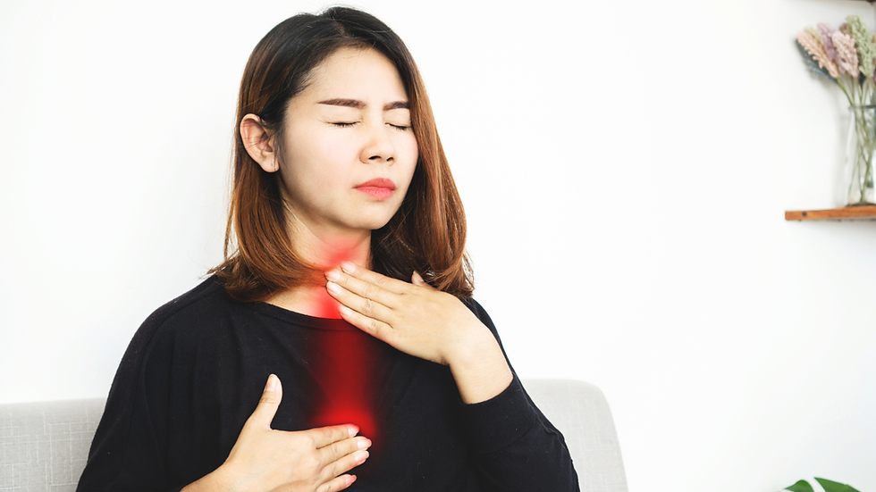 A woman experiencing discomfort holds her chest and throat, symptomatic of GERD.