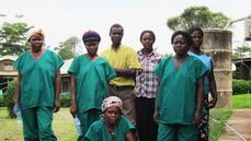 This image was taken on the grounds of Kagadi Hospital, in the Kibaale District of Uganda, during that nation’s July - August 2012, Ebola outbreak. Dressed in their green-colored scrubs, and white rubber boots, these were members of the hospital staff, who had stopped to pose for this quick portrait. Note the somber expressions each staff member displayed, reflecting the seriousness of their plight. According to the World Health Organization (WHO), it was inside the Kibaale District that the 2012, Ugandan Ebola outbreak began.