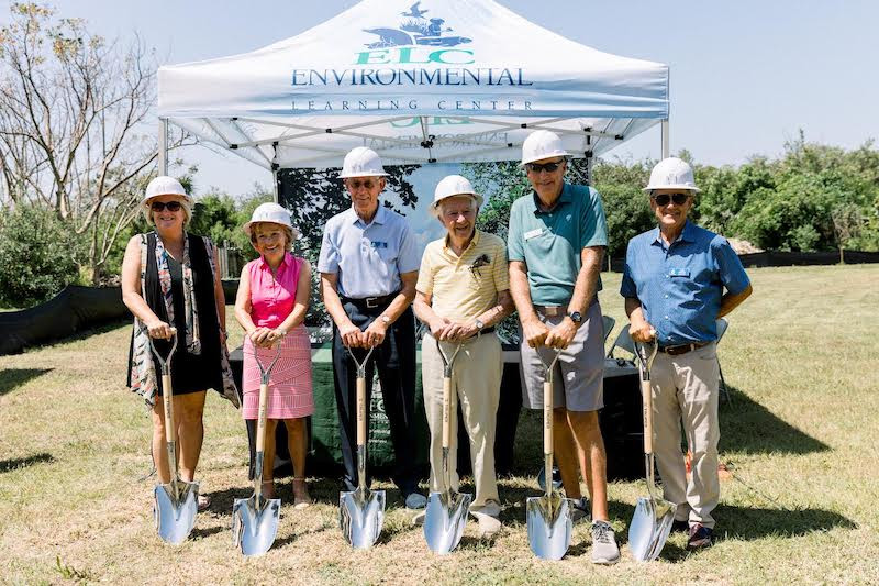 people with shovels and hard hats at groundbreaking ceremony
