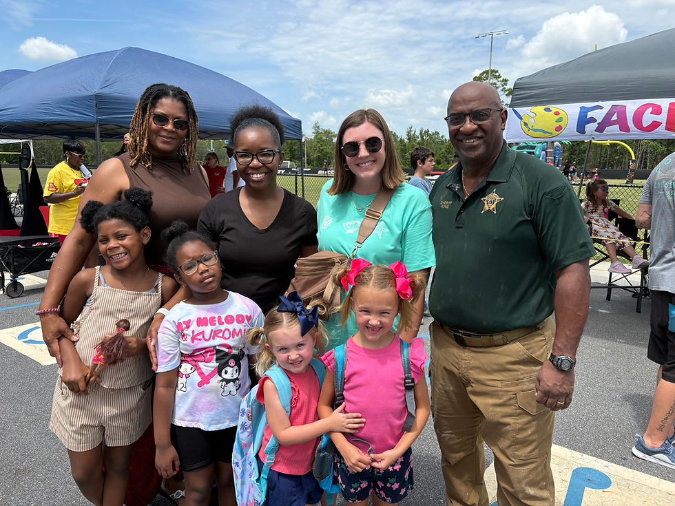 Diverse group at a Community Partnership outdoor event.