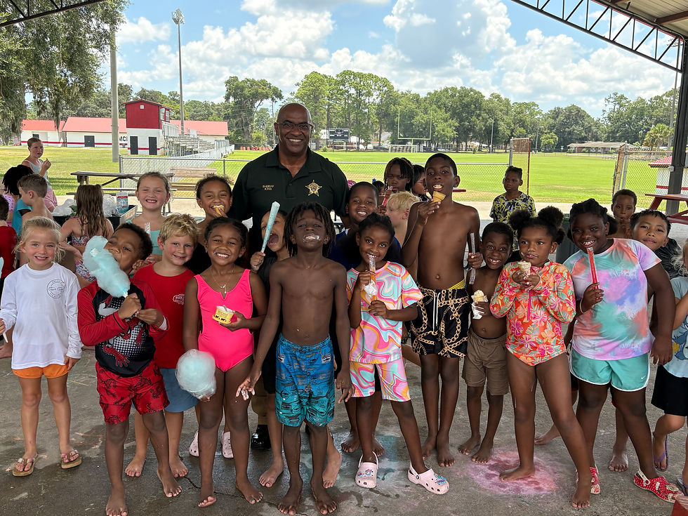 Sheriff with children enjoying a community partnership event