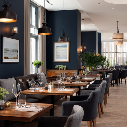 Elegant restaurant dining room with dark blue walls