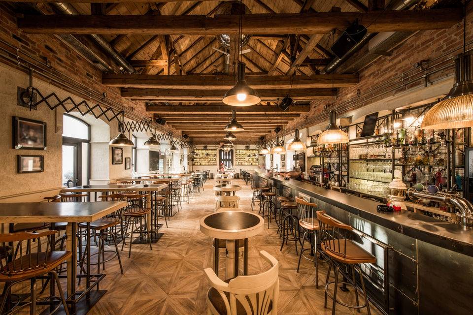 Rustic bar interior with wooden beams and warm lighting