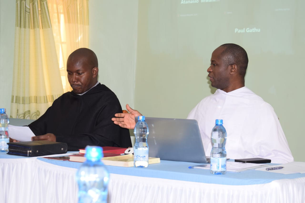 Father Edward Daniang Daleng, OSA with another priest of the Order presiding over the meeting seated at a desk.