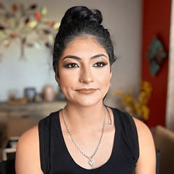 a woman wearing full face natural glam makeup in Ave Maria