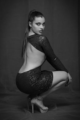 Modelo con vestido negro posando en estudio, foto de book en blanco y negro