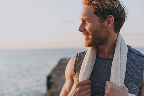 Close up happy young strong sporty athletic toned fit sportsman man in sports clothes towe