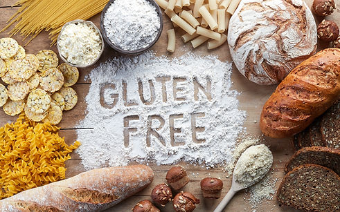 Gluten free food. Various pasta, bread, snacks and flour on wooden background from top vie
