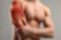 Muscular system. Athletic man with illustration of skeletal muscles on his arm, grey backg