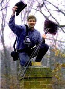 Aubrey Petro, owner of New River Chimney Co., holding chimney sweep brushes