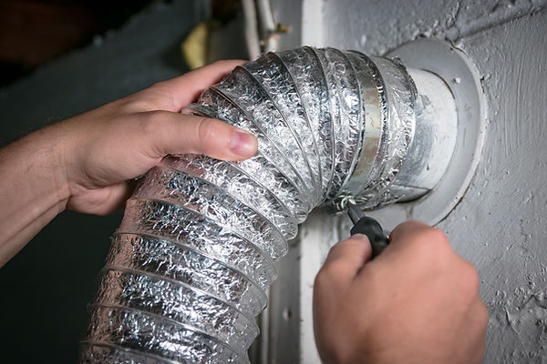 Technician cleaning a dryer vent duct in a Radford, VA home