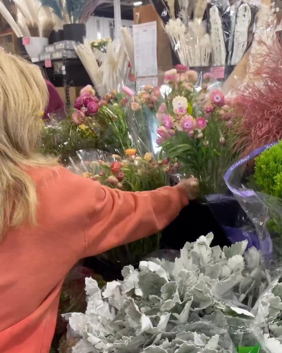 Providence Florist shop owner Pam hand selecting flowers