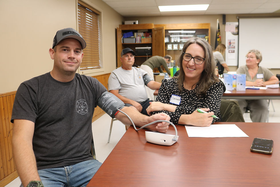 Volunteer Nurse Practitioner, Stephanie Greenfield screening a firefighter at a firehall