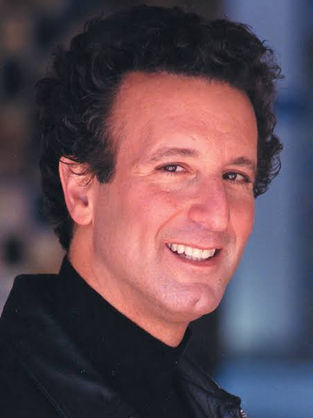 Bestselling author Jon Land wearing black, smiling at camera