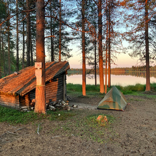 Sunset and a shelter with table and fresh firewood