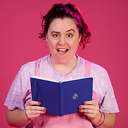 Beth against a bright pink backdrop, opening a blue notebook, looking scandalised with mouth open and one eyebrow raised.