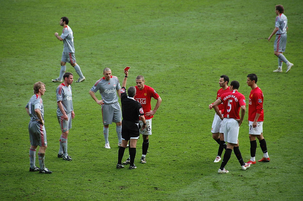 referee holding a red card