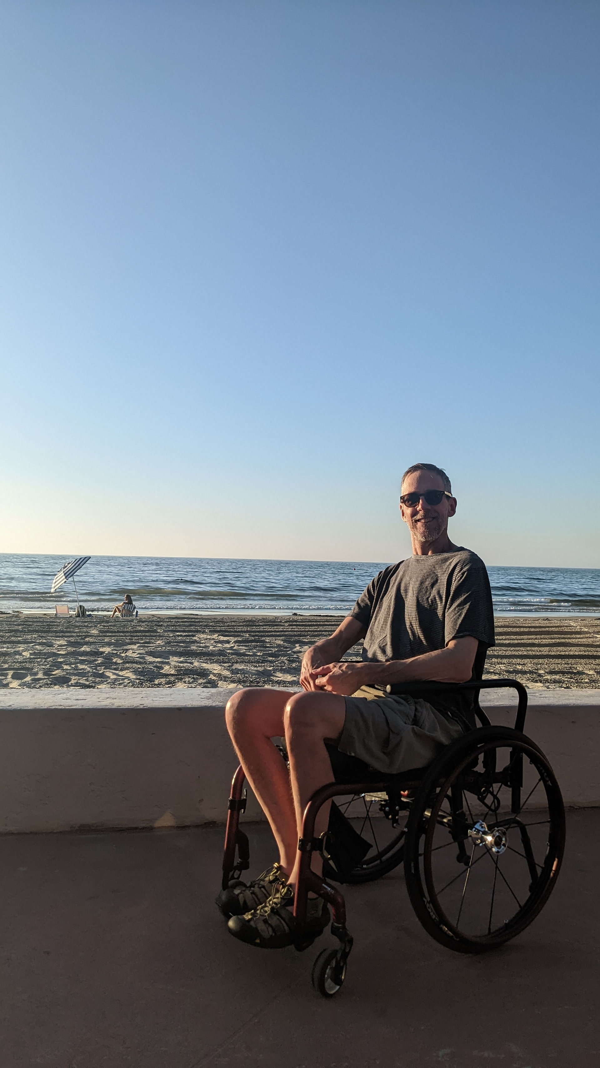 Dave near the beach in a wheelchair