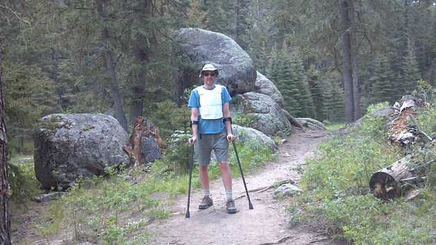Dave hiking on a trail with forearm crut
