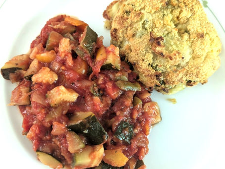 Batch cooked salmon fishcake with ratatouille on a white plate