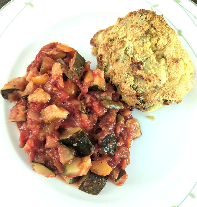 Batch cooked salmon fishcake with ratatouille on a white plate